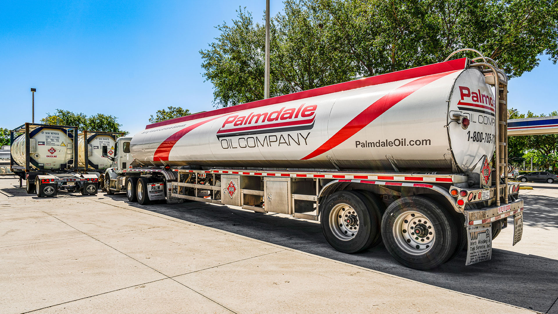 Bulk oil delivery truck parked in industrial area, delivering lubricant and fuel products to service facilities