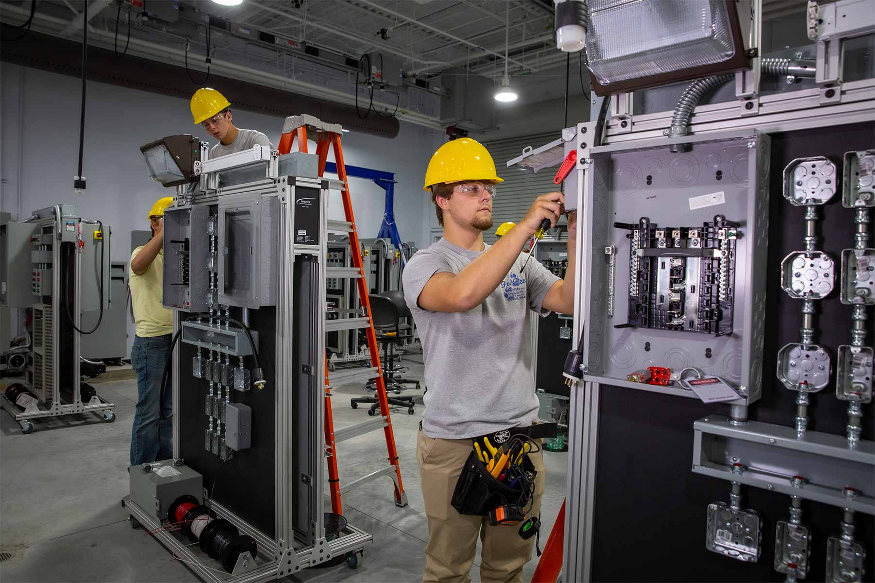 Technician transferring hydraulic oil using dedicated pump and clean transfer container